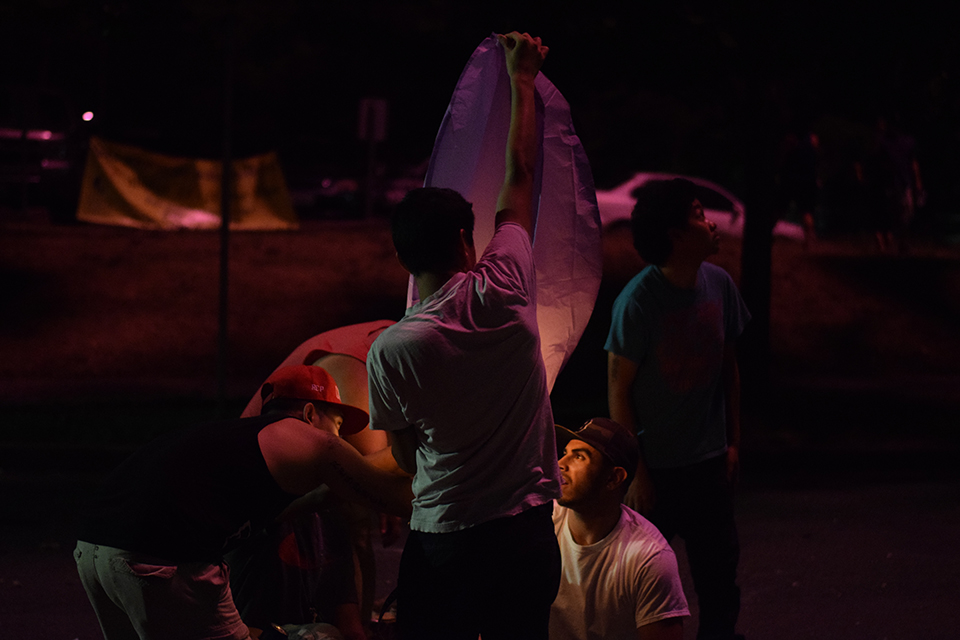 The guys lighting a paper lantern